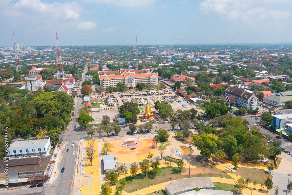 Fototapeta premium Aerial view of square landmark monument with residential neighborhood roofs. Urban housing development from above. Top view. Real estate in Isan urban city town, Thailand. Property real estate.