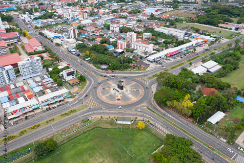 Aerial view of Buriram monument, a roundabout, with cars on busy street road in Bangkok Downtown skyline, urban city at sunset, Thailand. Landmark architecture landscape. photo