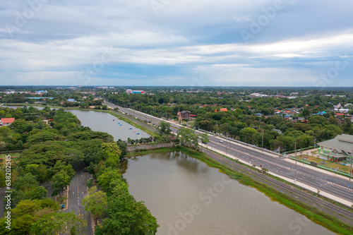 Aerial top view of a garden park with green forest trees, river, pond or lake. Nature landscape background, Thailand. © tampatra