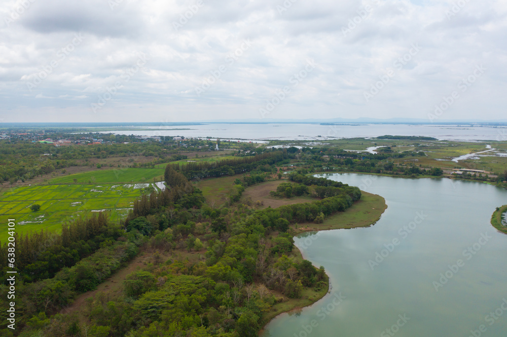 Aerial top view of a garden park with green forest trees, river, pond or lake. Nature landscape background, Thailand.