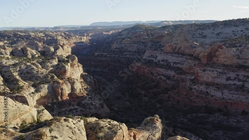 Flying over Calf Creek Escalante Utah from cliffside, gorgeous spring sunset