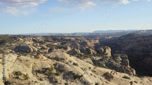 Panoramic aerial view of Calf Creek Escalante rock gorge, descending along cliff