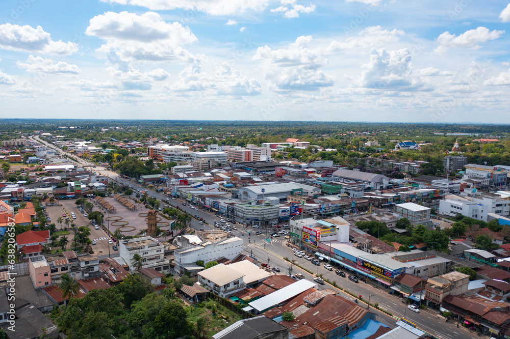 Naklejka premium Aerial view of local residential neighborhood roofs. Urban housing development from above. Top view. Real estate in Isan urban city town, Thailand. Property real estate.