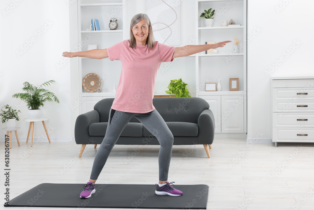 Senior woman in sportswear doing exercises on mat at home Senior woman in sportswear doing exercises on mat at home