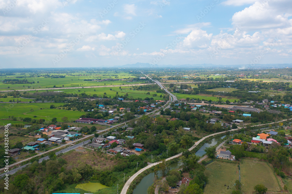 Aerial top view of fresh paddy rice, green agricultural fields in countryside or rural area in Asia, Thailand. Nature landscape