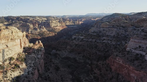 Soaring above shadow covered Calf Creek rock gorge in Escalante Utah, sunset