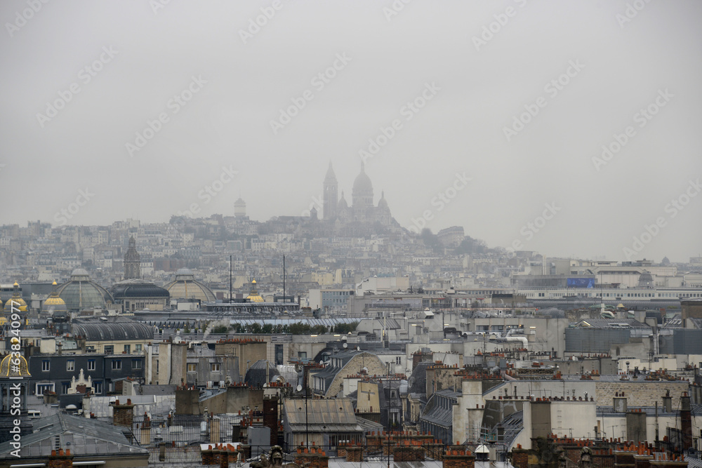 rain. The city of Paris shrouded in fog. overlooking Montmartre Hill