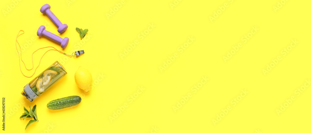 Sports bottle of cucumber lemonade with dumbbells and coach whistle on yellow background with space for text Sports bottle of cucumber lemonade with dumbbells and coach whistle on yellow background with space for text