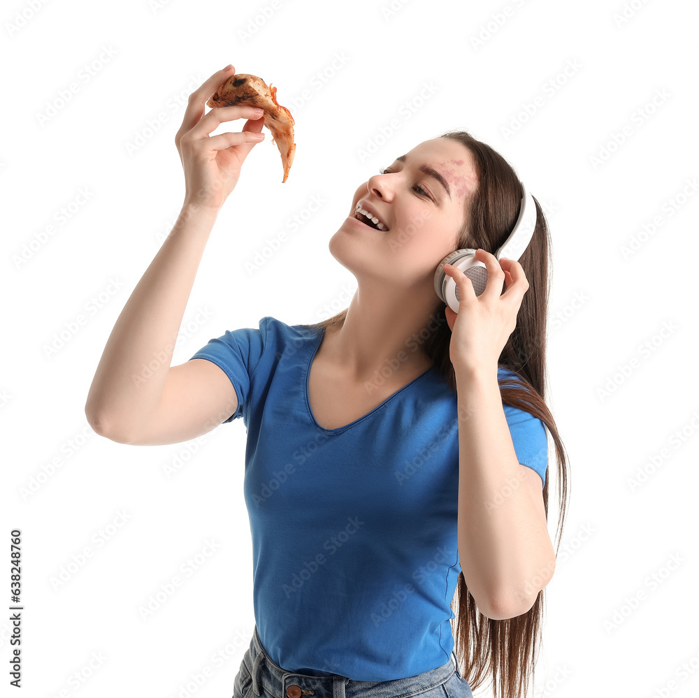 Young woman in headphones eating tasty pizza on white background Young woman in headphones eating tasty pizza on white background