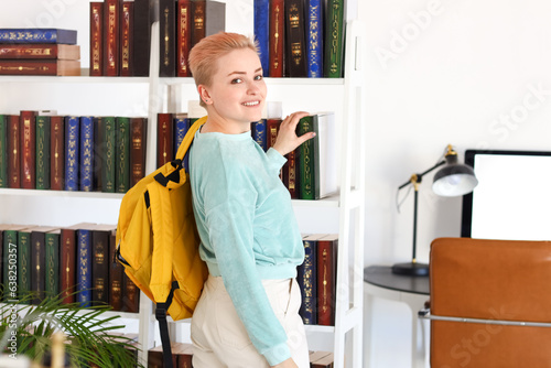 Female student taking book ...