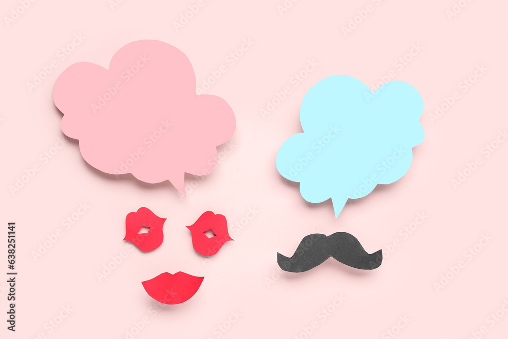 Paper lips and mustache with blank speech bubbles on pink background