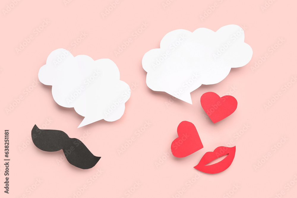 Paper mustache, lips and hearts with blank speech bubbles on pink background