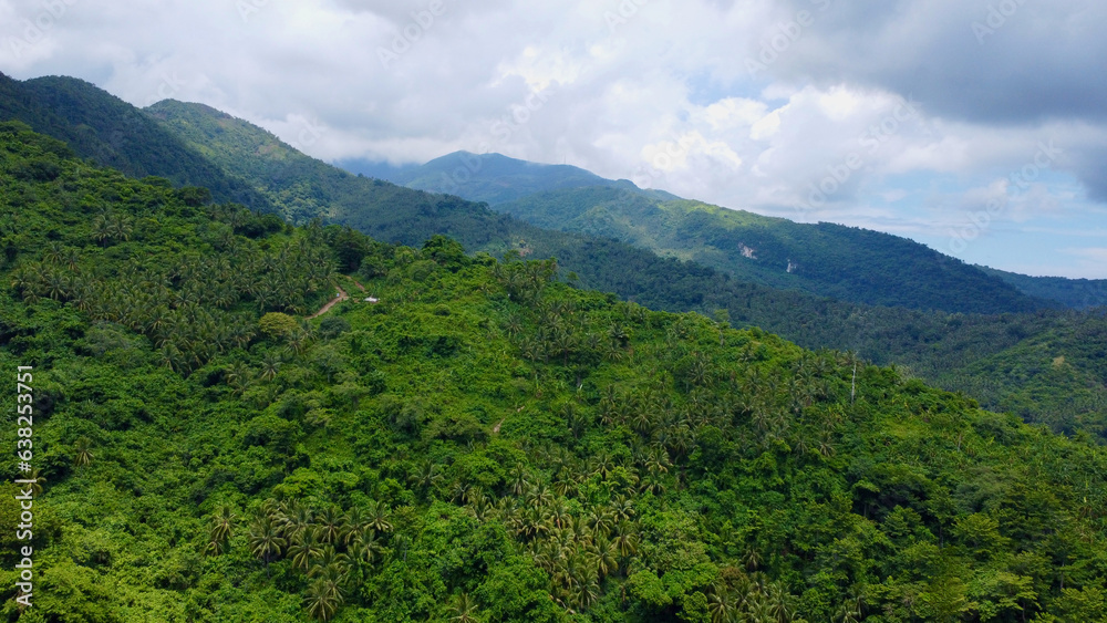 The slope of the mountain covered with jungle. Mountain range with peaks on a tropical island and storm clouds over the mountains.
