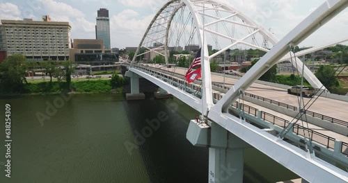 USA And Arkansas Flag On The Broadway Bridge With Traffic In Little Rock, Arkansas, USA. - aerial photo