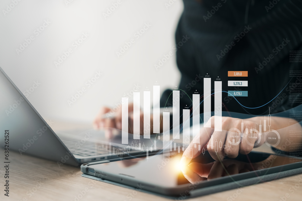 Businesswoman using tablet and laptop analyzing business growth graph data and progress, compass of navigate guiding market direction. Investment, banking and finance, strategy, Global economy.