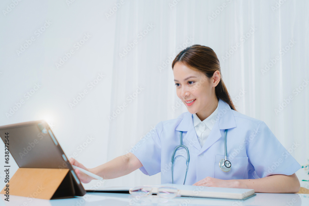 female doctor with tablet pc computer at hospital, Doctor working with laptop computer and writing in hospital history document female doctor with tablet pc computer at hospital, Doctor working with laptop computer and writing in hospital history document