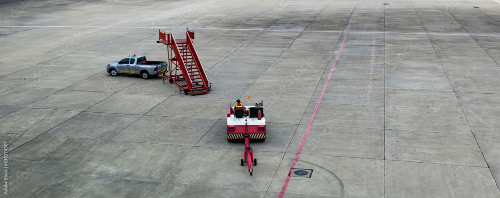 Airplane tow tractor at the airport apron near the terminal. Aircraft ...