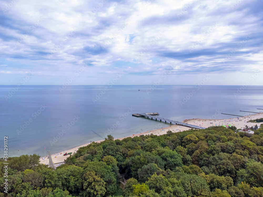 Aerial view landscape, view of forest, horizon, sea and blue sky in Kolobrzeg pier