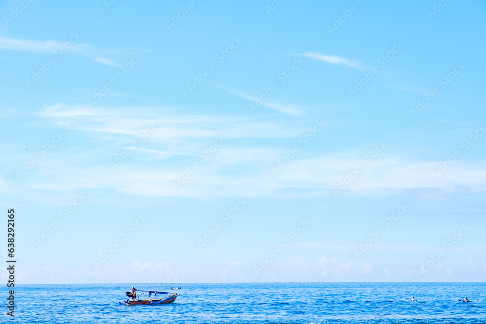 sawarna beach,a view of the beautiful, blue sea sky and fishermen sailing. 