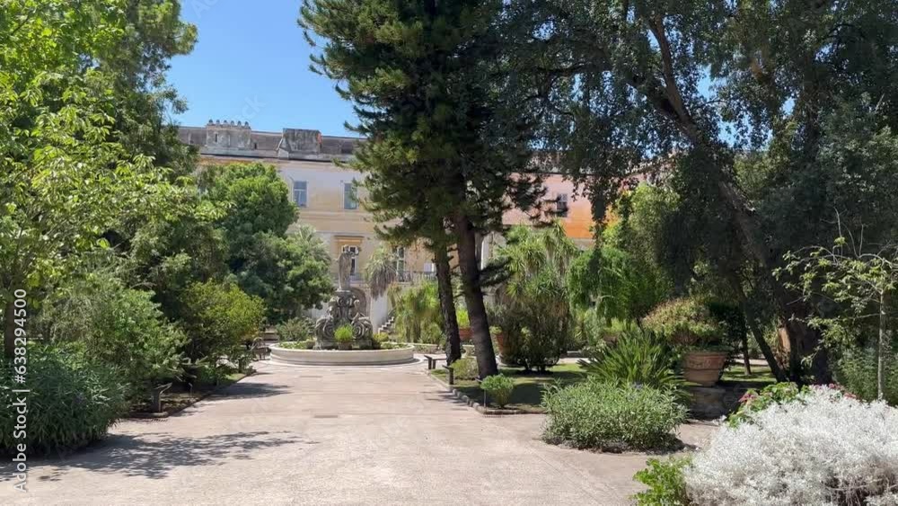Botanical garden near the Summer Residence (palace) of the Neapolitan Kings in the city of Portici, Italy. A quiet place, summer coolness from tall trees, a city park Botanical garden near the Summer Residence (palace) of the Neapolitan Kings in the city of Portici, Italy. A quiet place, summer coolness from tall trees, a city park