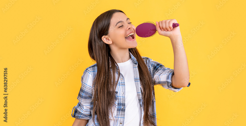 teen girl singing with hairbrush on background. photo of teen girl with hairbrush in hand. teen girl singing with hairbrush on background. photo of teen girl with hairbrush in hand.