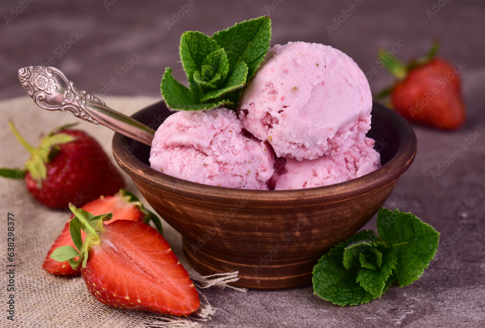 Homemade strawberry ice cream in a clay bowl. Close-up.
Homemade strawberry ice cream in a clay bowl. Close-up.