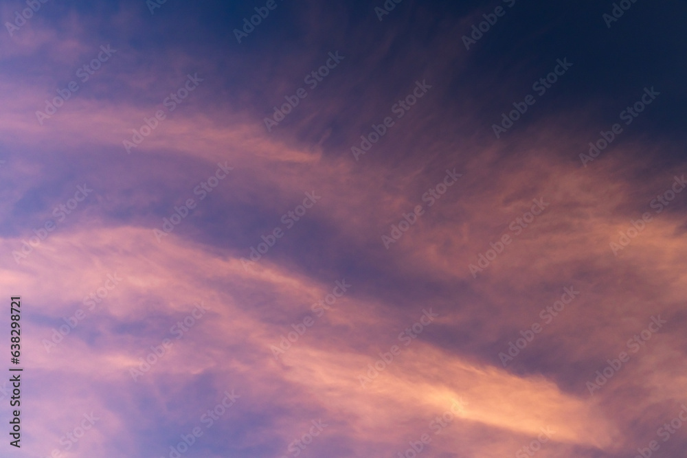 Colorful sky with pink cirrus clouds at sunset, natural texture