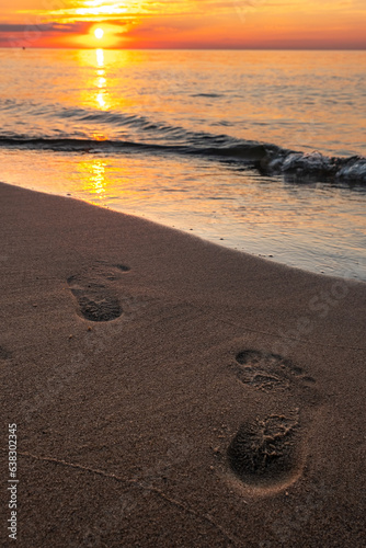 Footprints on the beach at sunset © fotogutek