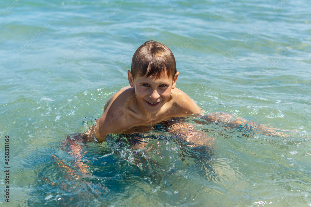Happy boy swims and dives underwater. water sports and activities with parents on summer Happy boy swims and dives underwater. water sports and activities with parents on summer