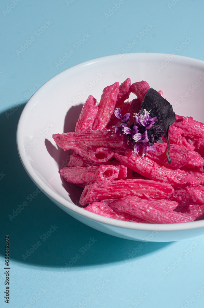 Delicious trendy pink beetroot pasta on minimalist blue background recipe copy space stylish flat lay Delicious trendy pink beetroot pasta on minimalist blue background recipe copy space stylish flat lay
