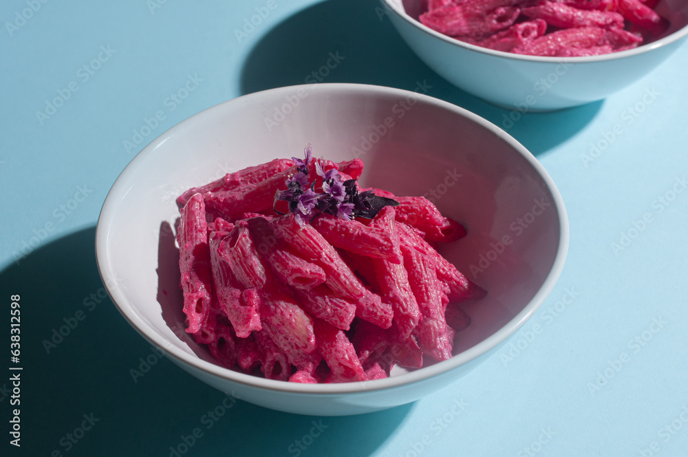 Delicious trendy pink beetroot pasta on minimalist blue background recipe copy space stylish flat lay