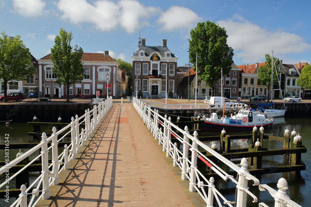 Historic buildings and the Stadhuis (Town Hall) viewed from the Raadhuisbrug bridge in Noorderhaven, Harlingen, Friesland, Netherlands