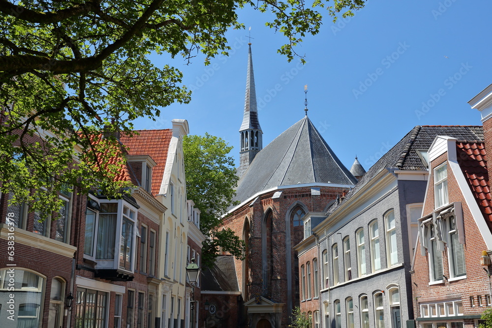 Obraz premium Jacobijnerkerk church viewed from Bij de Put street in Leeuwarden, Friesland, Netherlands, with historic buildings in the foreground