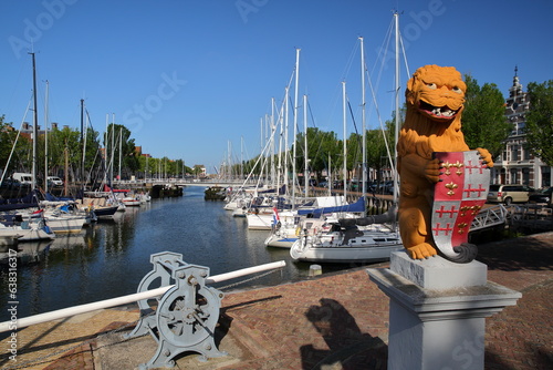 Statue of a lion (dated from 1610) which carries the city coat of arms at Rommelhaven in Noorderhaven, Harlingen, Friesland, Netherlands  photo
