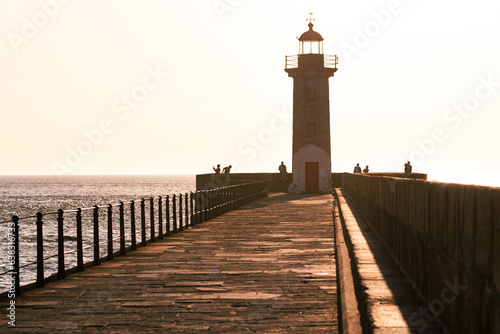 Farol de Felgueiras, at the edge of a port at sunset. Porto Portugal. Maritime navigation safety