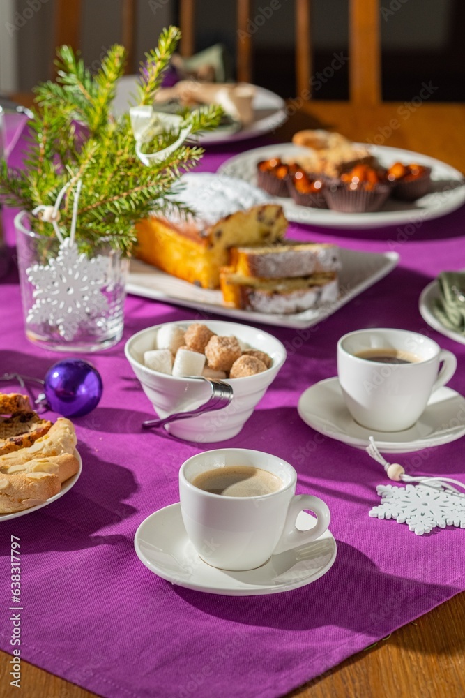 Coffee table setting with white tableware in Christmas style on a table with a purple tablecloth. Merry Christmas concept. Receiving guests, Coffee table setting with white tableware in Christmas style on a table with a purple tablecloth. Merry Christmas concept. Receiving guests,