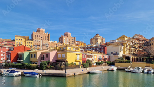 Obraz na płótnie Walk through the streets and canals of the port of Saplaya on a sunny day. Moored yachts and boats at the bright facades of houses. Spain w salonie