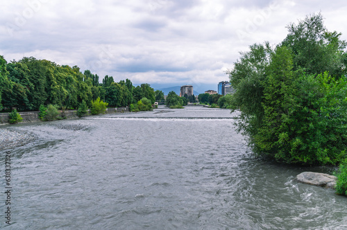 The overflowing mountain river flowing through the city during the rainy season. The Terek River in the city of Vladikavkaz. photo