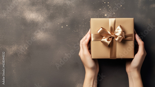 Hands Offering a Gift Box with a Bow, Extended Towards the Viewer , Christmas, aesthetics, wide banner with copy space area 