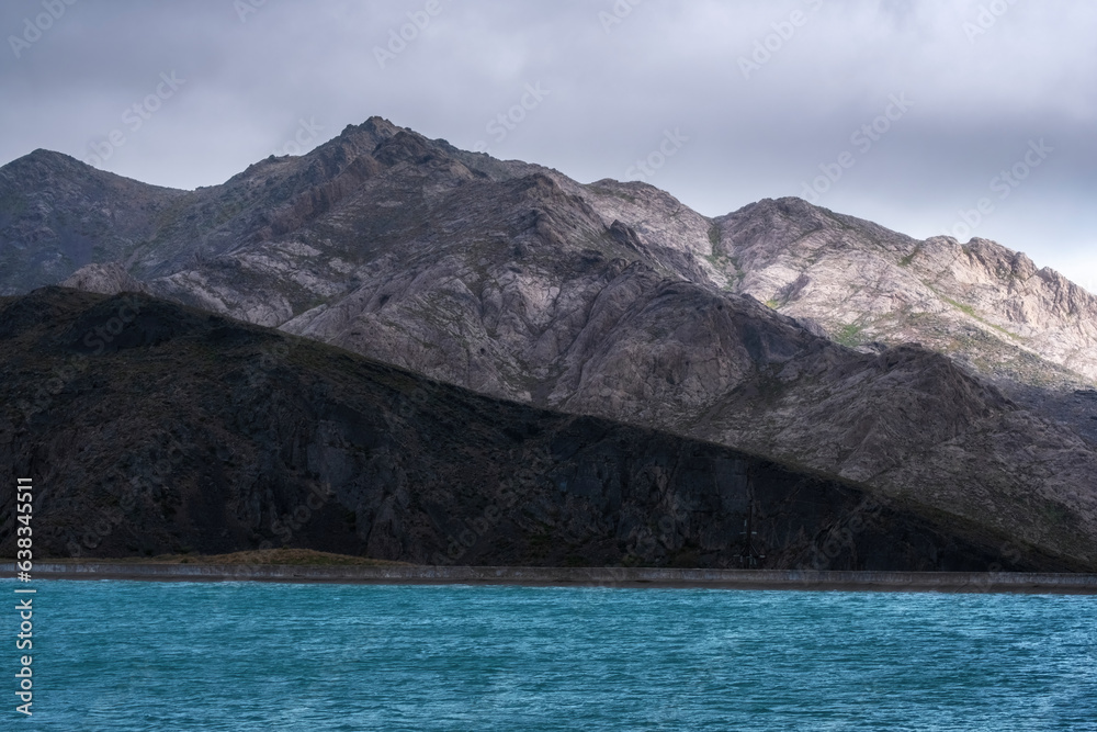 Blue water reservoir in the mountains of South Kazakhstan in gorge and Achysay Pass