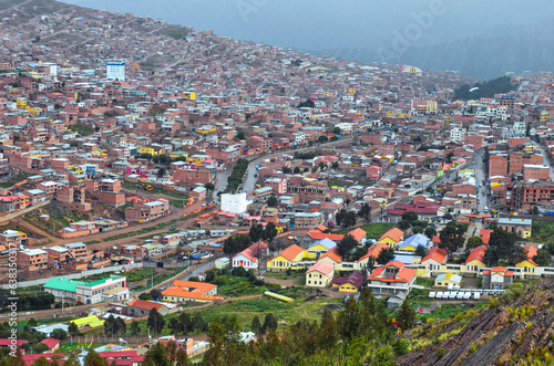 Distant high view of Potosi city. Colorful neighborhoods, houses and rooftops in a city exploited by the mining system for centuries, living in poverty. Bolivia. Southamerica