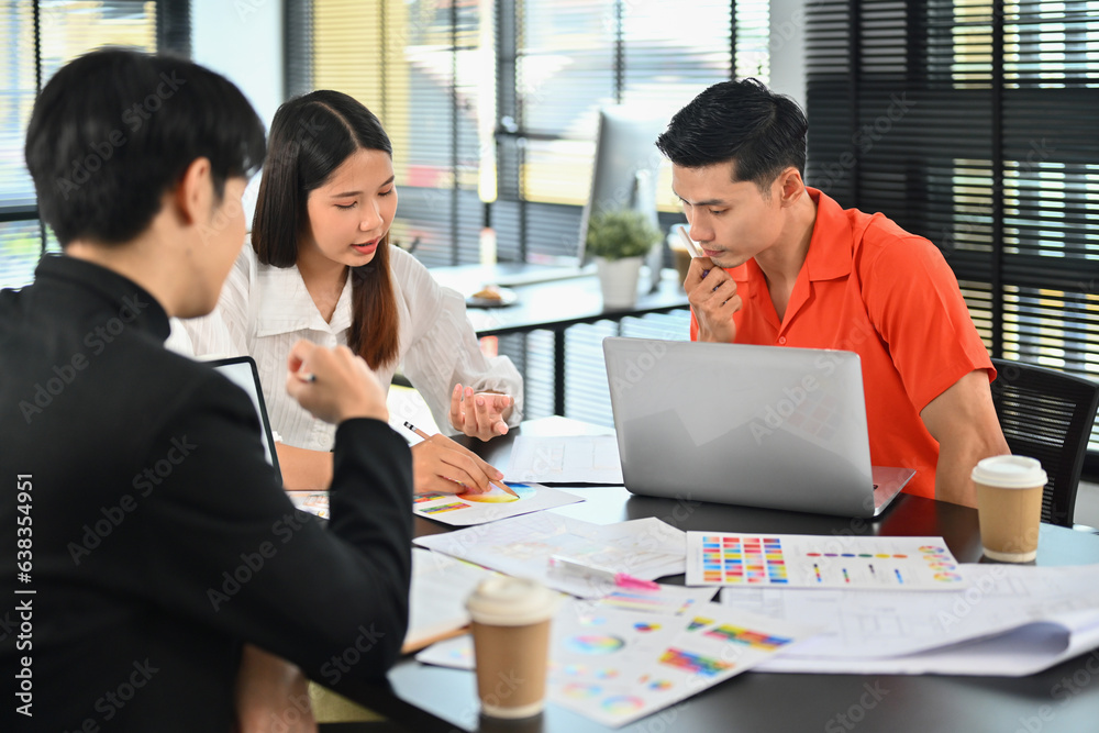 Team of interior designer brainstorming together over joint building project in modern office Team of interior designer brainstorming together over joint building project in modern office