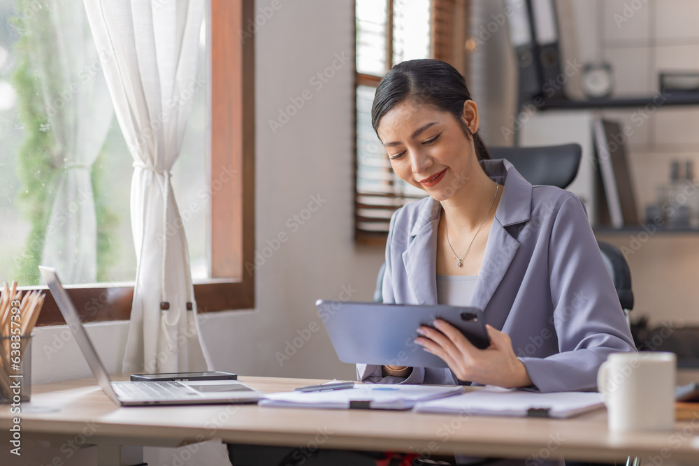 Financial Businesswomen analyze do on tablet the graph of the company's performance to create profits and growth, asian Market research reports and income statistics, Financial and Accounting concept. Financial Businesswomen analyze do on tablet the graph of the company's performance to create profits and growth, asian Market research reports and income statistics, Financial and Accounting concept.