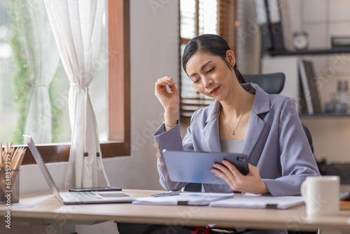 Financial Businesswomen analyze do on tablet the graph of the company's performance to create profits and growth, asian Market research reports and income statistics, Financial and Accounting concept.