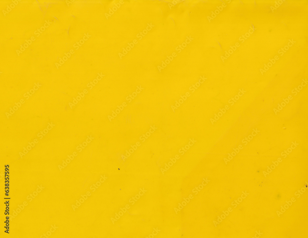 Grunge yellow plastic background template. Smooth and vibrant surface texture.