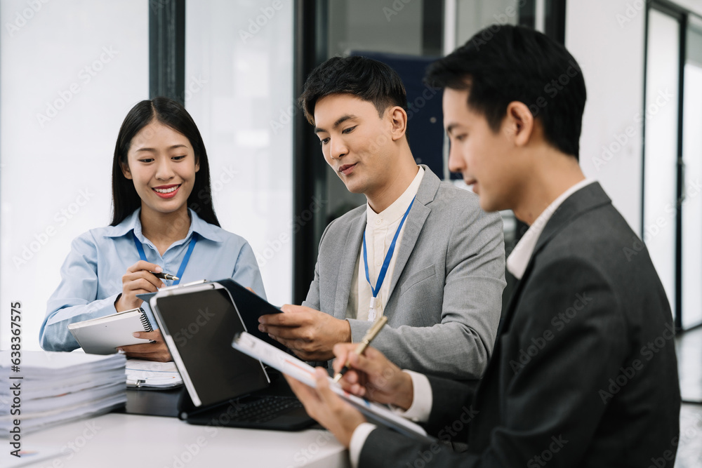 Businessmen team or financial data analysts working with tablets and laptop computers and data graphs together. Plan to analyzing projects in the office.