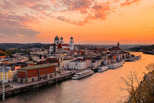 Passau, UNESCO. Exclusive historical town with Castle and Church at sunset. Beautiful spring evening landscape with an illuminated monument and Danube river. Shiny premium cityscape scene from Germany