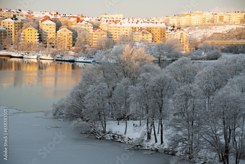 Landscape of river and buildings in central Stockholm on a snowy winter day in Stockholm