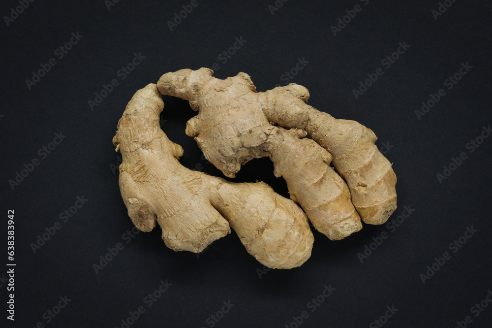 Fresh Ginger roots on black background