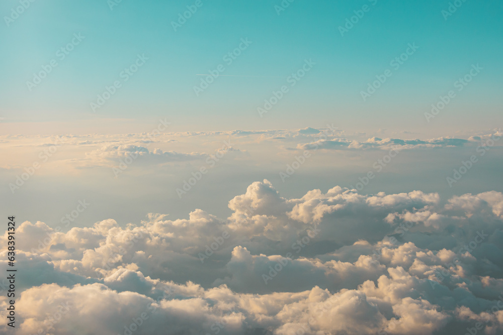 Aerial cloudscaspe view of the picturesque clouds and sky from a height in the morning at dawn over the horizon.
